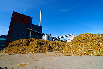 Image showing bio power plant with storage of wooden fuel against blue sky