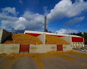 Image showing bio power plant with storage of wooden fuel against blue sky