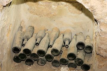 Image showing Old wine bottles in the wall