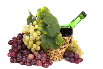 Image showing white and red grape with leaves and bottle of wine