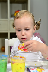 Image showing little girl draws with colored inks 