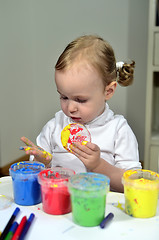 Image showing little girl draws with colored inks 