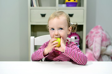 Image showing little girl eating green apple