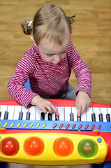 Image showing little girl playing the piano