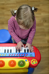 Image showing little girl playing the piano