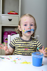 Image showing little girl and colored paints