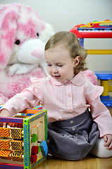 Image showing little girl in a room with toys