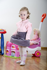 Image showing little girl standing in a room with toys