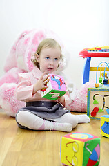 Image showing little girl in a room with toys