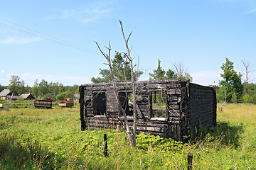 Image showing burned rural house on green field