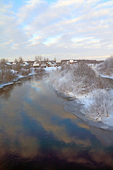 Image showing snow village on coast river