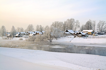 Image showing winter village on coast river 