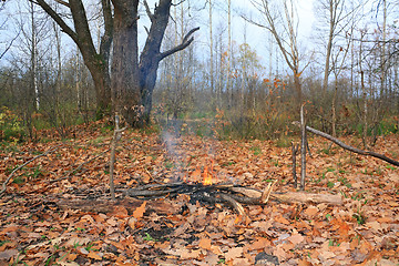 Image showing small campfire amongst yellow sheet