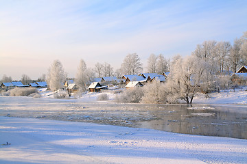 Image showing winter village on coast river 