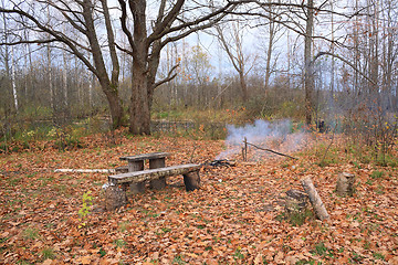 Image showing small campfire amongst yellow sheet