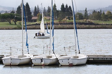Image showing three sailing boats with mountain in background