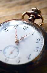 Image showing vintage pocket watch on wooden background 