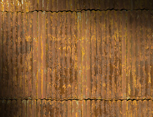 Image showing Rusty corrugated metal roof panels lit diagonally
