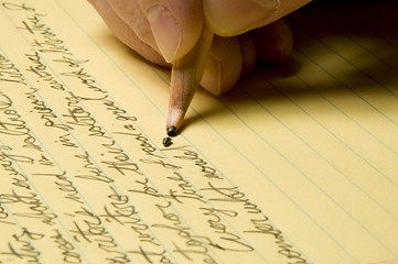 Image showing Handwriting with broken pencil point on yellow pad