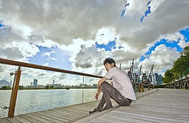 Image showing asian man sitting in park