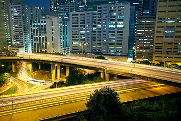 Image showing Colorful city night with buildings and bridge