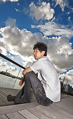 Image showing asian man sitting in park