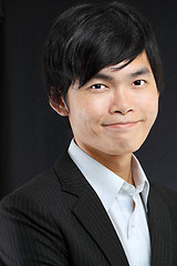 Image showing Young asian man in black suit