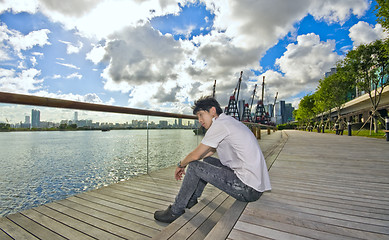 Image showing asian man sitting in park