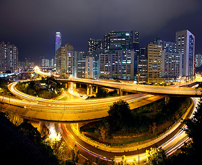 Image showing Colorful city night with buildings and bridge