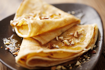 Image showing crepes with honey or syrup and roasted nuts