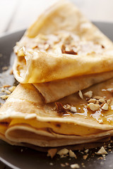 Image showing crepes with honey or syrup and roasted nuts