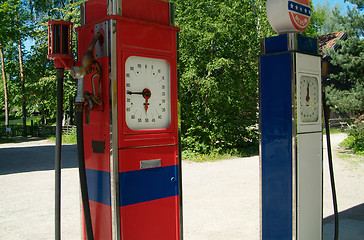 Image showing Two old gasoline pumps