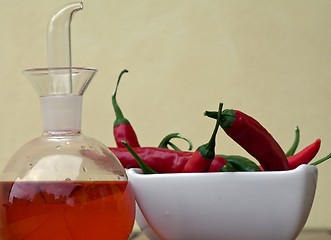 Image showing Chilli peppers and spicy oil