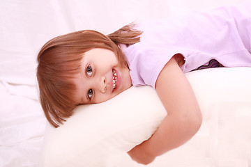 Image showing Beautiful little girl lying on bed 