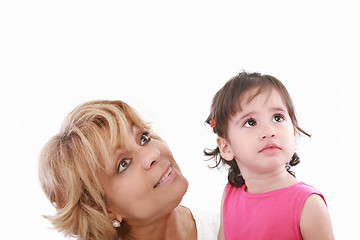 Image showing Cute girl and attractive young woman both looking up