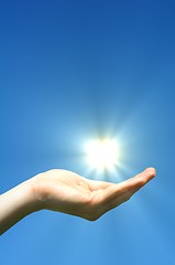 Image showing hand sun and blue sky