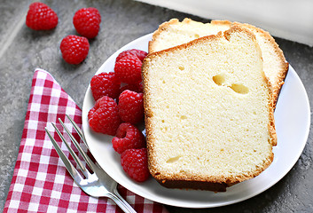 Image showing Two sliced fresh pound cake with raspberries. Selective focus on