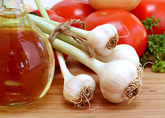 Image showing Fresh Garlic with stems and tied with twine, tomatoes, parsley, 