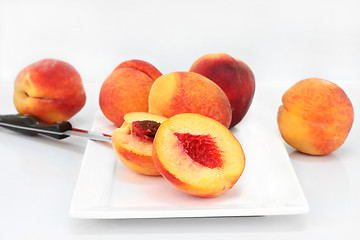 Image showing Farm fresh peaches cut and whole