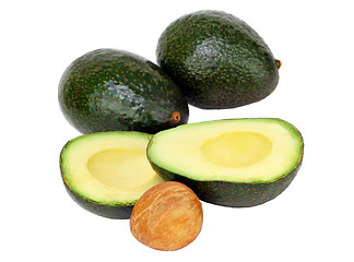 Image showing Avocados on white, cut and whole with pit.