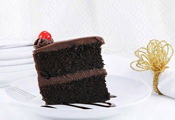 Image showing Chocolate Fudge Cake with Cherry in Elegant Table Setting