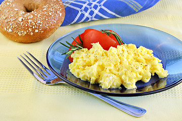 Image showing Scrambled eggs with tomatoes and fresh rosemary.