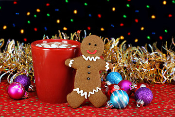 Image showing Cocoa and a gingerbread cookie in night setting with Christmas l