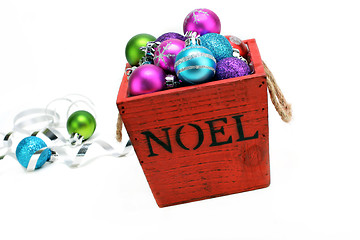 Image showing Christmas ornaments in a wooden box with NOEL stenciled on the f