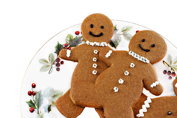 Image showing Fresh baked gingerbread men cookies on a Christmas Plate.  On wh