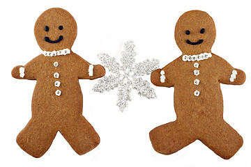 Image showing Two Gingerbread Man Cookies Holding a Snowflake