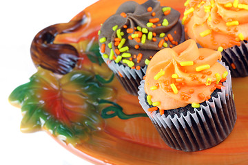 Image showing Autumn cupcakes on Pumpkin plate.