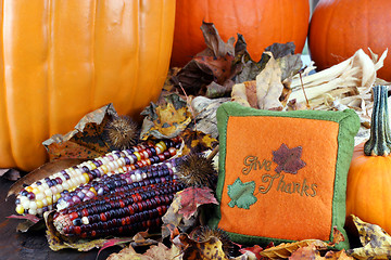 Image showing Pumpkins, leaves and Indian corn with a Give Thanks pillow.