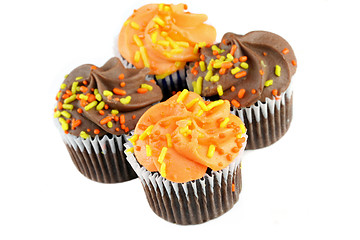 Image showing Autumn decorated chocolate cupcakes on white with copy space.