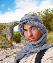 Image showing tourist hiding his head under a shawl